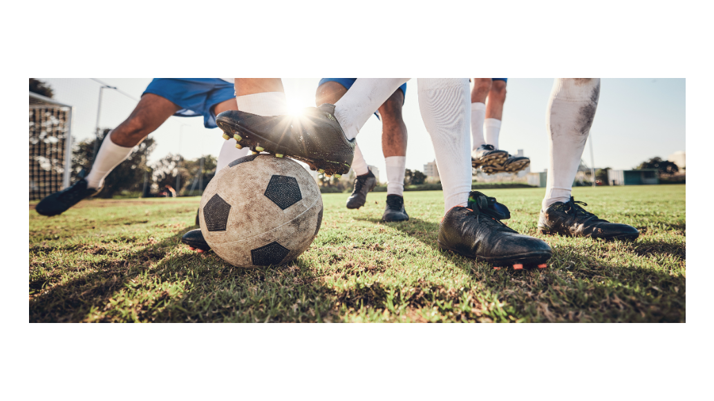 A view of soccer players' feet play for a soccer ball